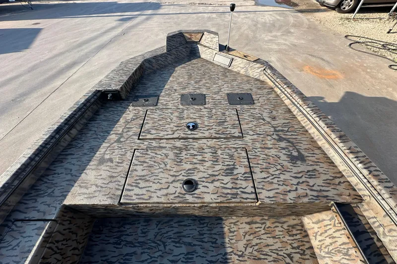 Slide: The Image of 2026 Xpress X18DB boat with camouflage pattern, featuring storage compartments and a clean deck. - 16