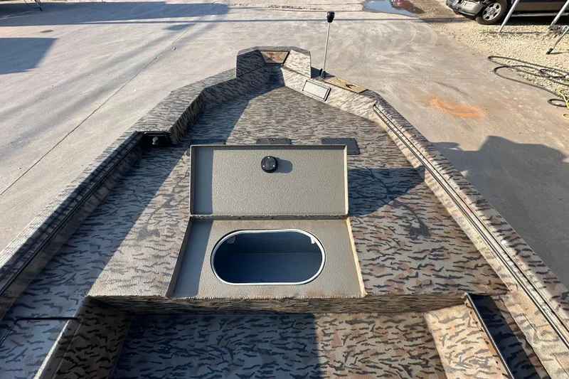 Slide: The Image of 2026 Xpress X18DB boat with camo pattern and open storage compartment. - 17