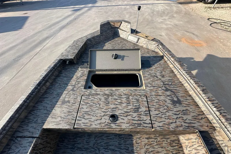 Slide: The Image of 2026 Xpress X18DB boat with camo pattern and open storage compartment on deck. - 18