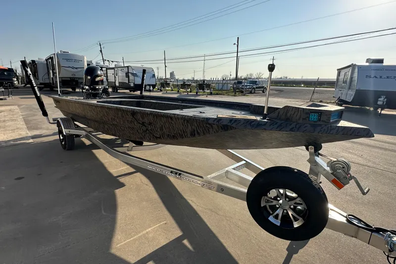 Slide: The Image of 2026 Xpress X18DB boat on trailer, parked outdoors under clear sky. - 2