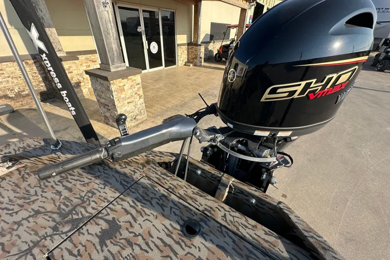 Slide: The Image of 2026 Xpress X18DB boat with Yamaha SHO VMAX engine, parked outside a building. - 21