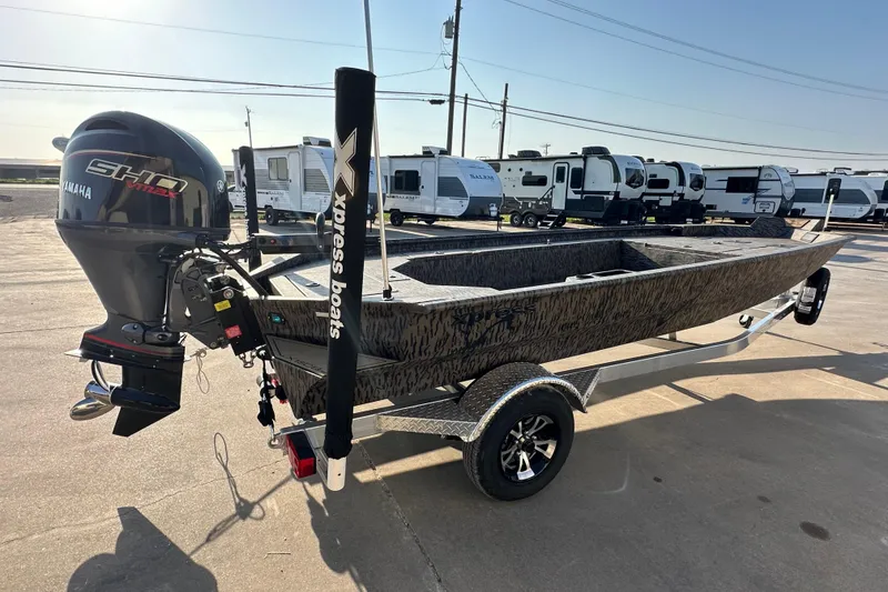 Slide: The Image of 2026 Xpress X18DB boat with Yamaha engine, parked on a trailer in a lot. - 3