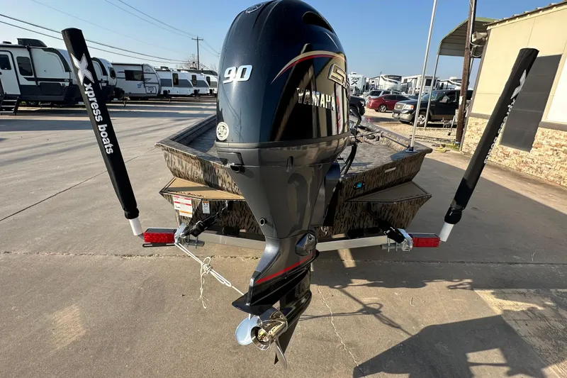 Slide: The Image of 2026 Xpress X18DB boat with Yamaha 90 engine, parked on a trailer. - 4
