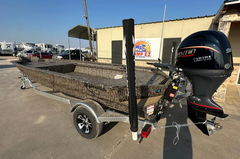 Slide: The Image of 2026 Xpress X18DB boat with Yamaha engine on trailer, parked outdoors. - 5