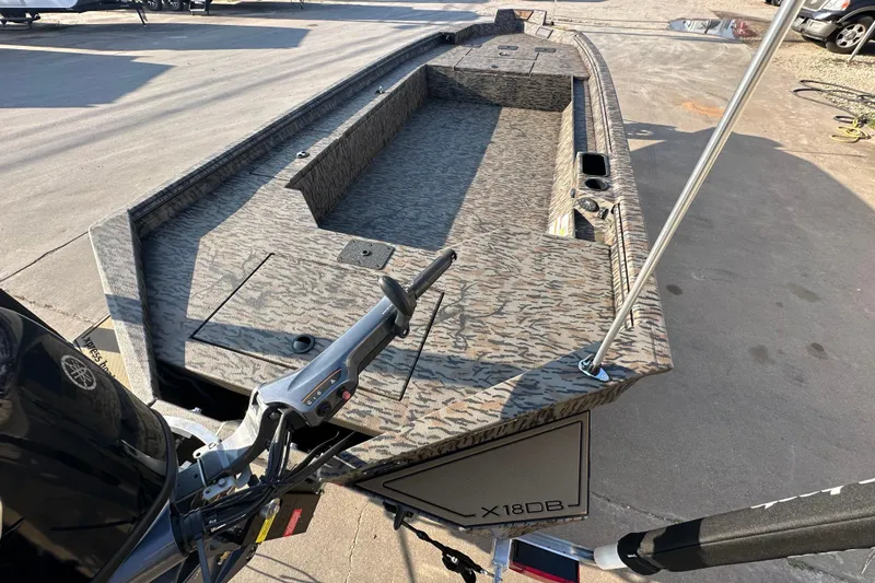 Slide: The Image of 2026 Xpress X18DB boat with camouflage design, featuring spacious deck and modern controls. - 8