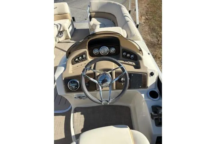 Slide: The Image of 2016 Bennington 2375 GCW boat dashboard with steering wheel and control panel. - 10