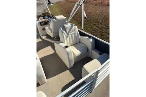 Slide: The Image of 2016 Bennington 2375 GCW boat interior with beige seating and steering console. - 11