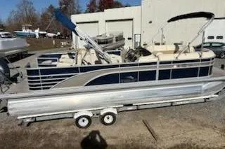 Slide: The Image of 2016 Bennington 2375 GCW pontoon boat on trailer, parked outdoors. - 5
