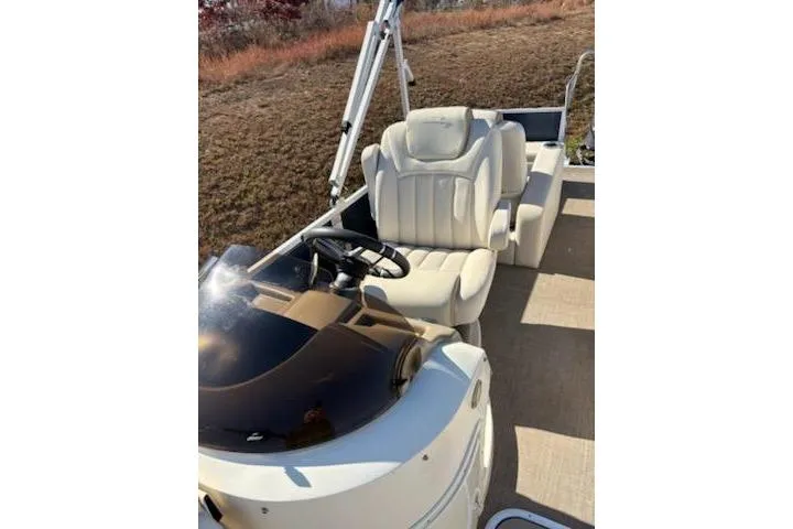 Slide: The Image of 2016 Bennington 2375 GCW boat with beige seating and steering console. - 8