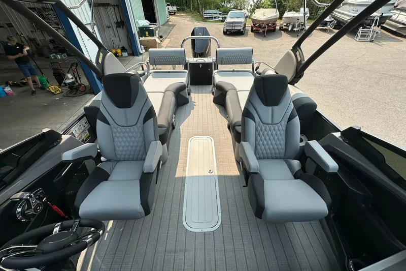 Slide: The Image of 2025 Avalon Excalibur LTD Quad Lounge Windshield boat interior with luxurious seating. - 15