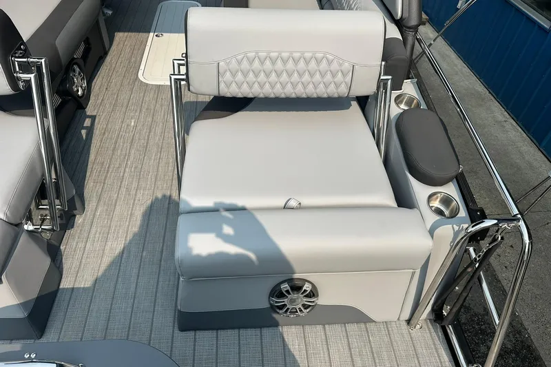 Slide: The Image of 2025 Avalon Excalibur LTD Quad Lounge Windshield boat interior with luxurious seating and cup holders. - 19