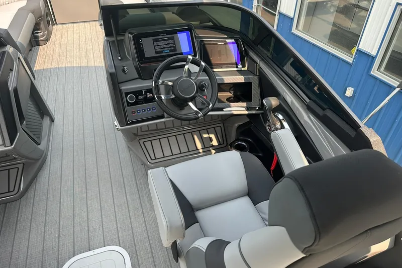 Slide: The Image of 2025 Avalon Excalibur LTD Quad Lounge Windshield boat interior with modern dashboard and seating. - 21