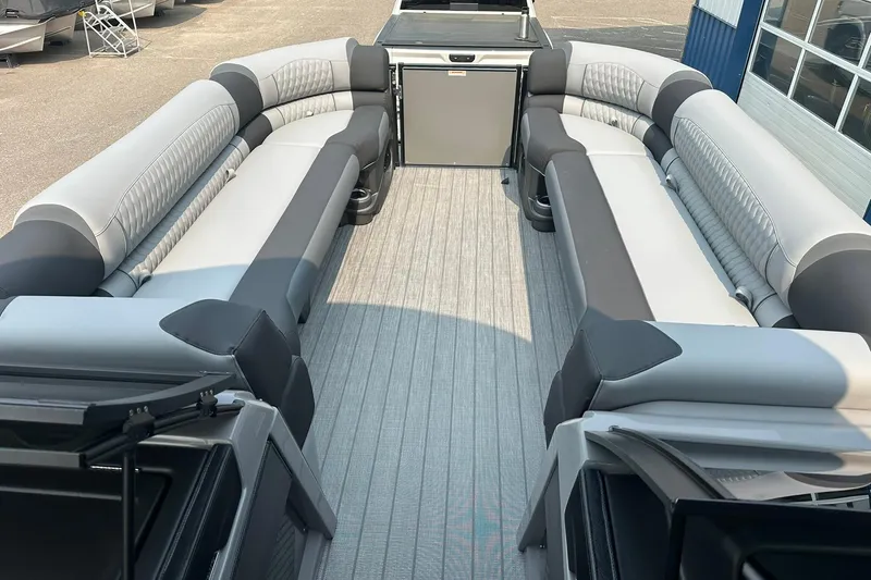Slide: The Image of 2025 Avalon Excalibur LTD Quad Lounge Windshield boat interior with spacious seating and modern design. - 25