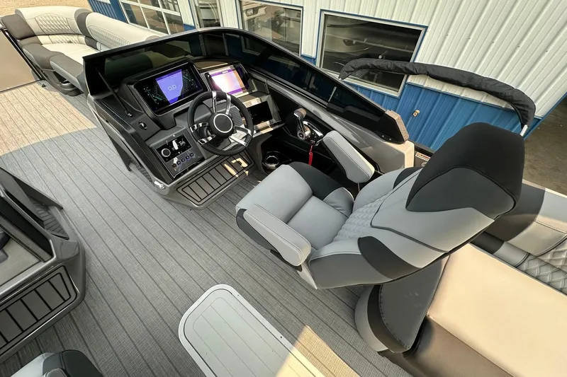 Slide: The Image of 2025 Avalon Excalibur LTD Quad Lounge Windshield boat interior with modern dashboard and seating. - 27