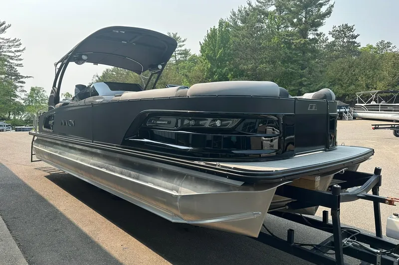 Slide: The Image of 2025 Avalon Excalibur LTD Quad Lounge Windshield pontoon boat on trailer. - 4