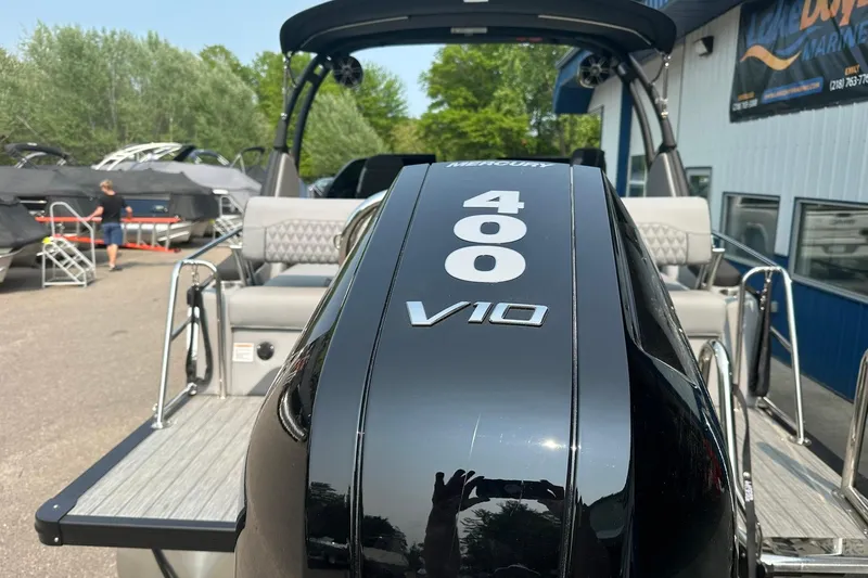 Slide: The Image of 2025 Avalon Excalibur LTD boat with Mercury 400 V10 engine, docked outdoors. - 6