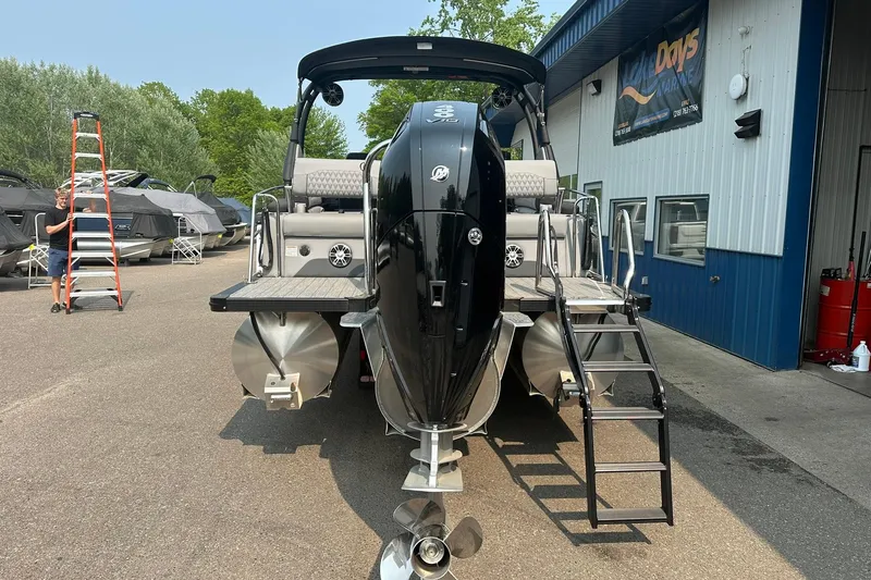 Slide: The Image of 2025 Avalon Excalibur LTD Quad Lounge Windshield boat at marina, rear view. - 7