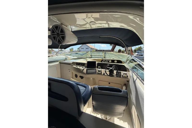 Slide: The Image of Interior view of 1998 Sea Ray 420 Sundancer yacht cockpit with steering wheel and controls. - 11