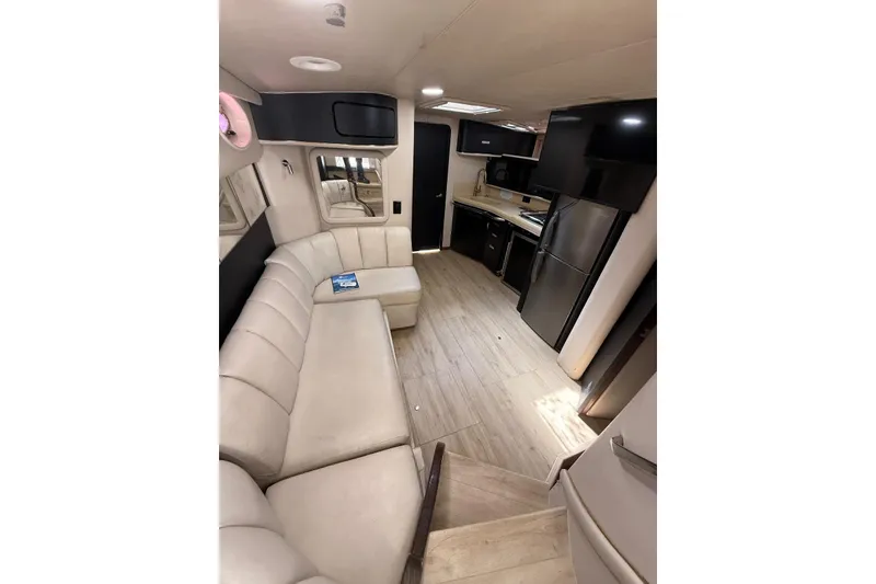 Slide: The Image of Interior of 1998 Sea Ray 420 Sundancer yacht with modern kitchen and seating area. - 13