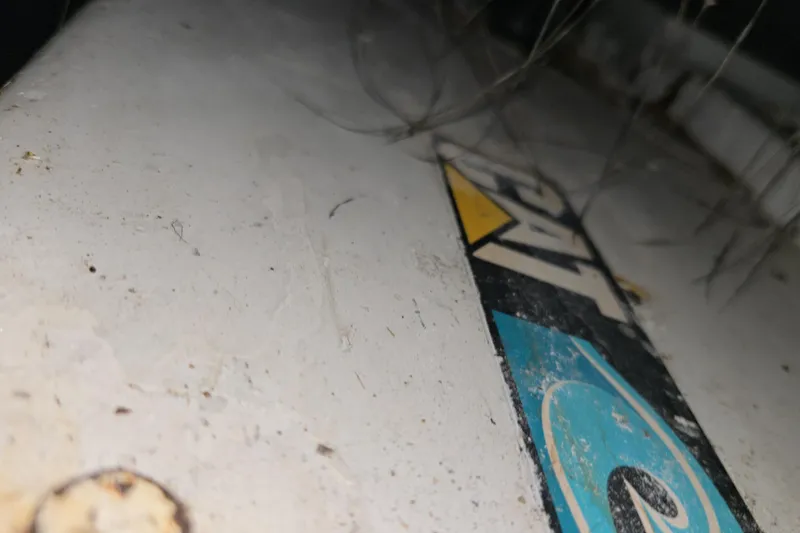 Slide: The Image of Close-up of a 1998 Sea Ray 420 Sundancer boat with visible logo and surface details. - 3