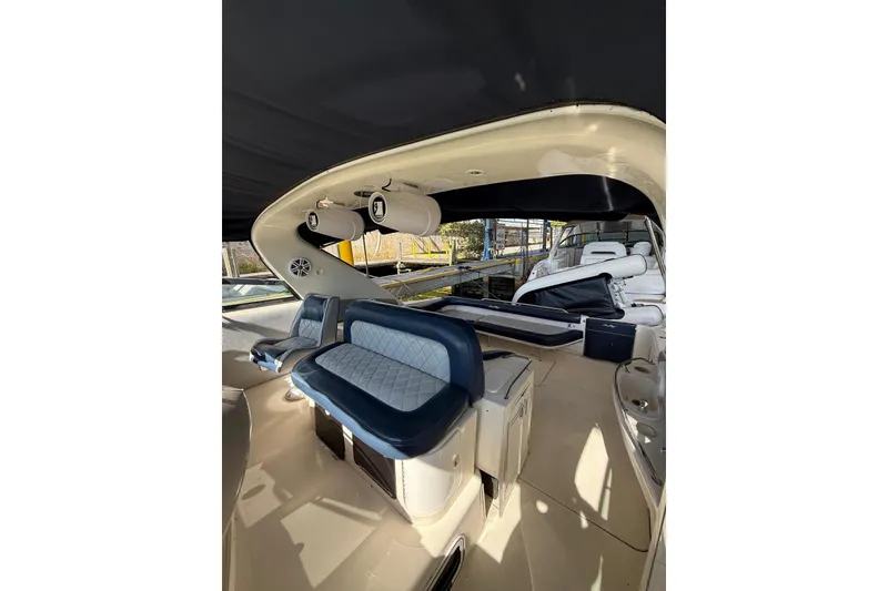 Slide: The Image of 1998 Sea Ray 420 Sundancer interior with blue seating and overhead speakers. - 4