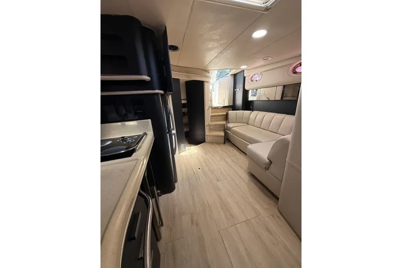 Slide: The Image of Luxurious interior of 1998 Sea Ray 420 Sundancer yacht with modern seating and kitchenette. - 6