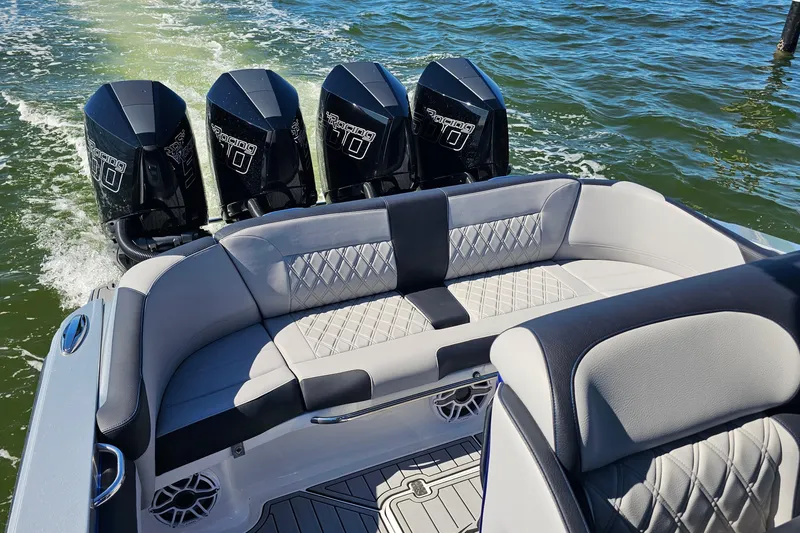 Slide: The Image of 2025 Nor-Tech 390 Sport Center Console with quad engines, luxurious seating, on open water. - 10