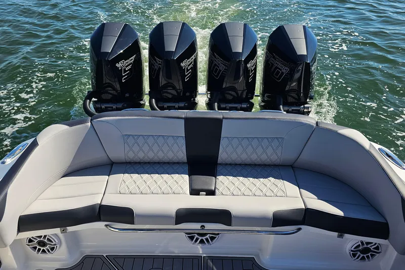 Slide: The Image of 2025 Nor-Tech 390 Sport Center Console with four powerful outboard engines on water. - 11