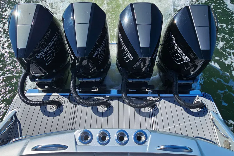 Slide: The Image of Four powerful outboard engines on a 2025 Nor-Tech 390 Sport Center Console boat. - 13