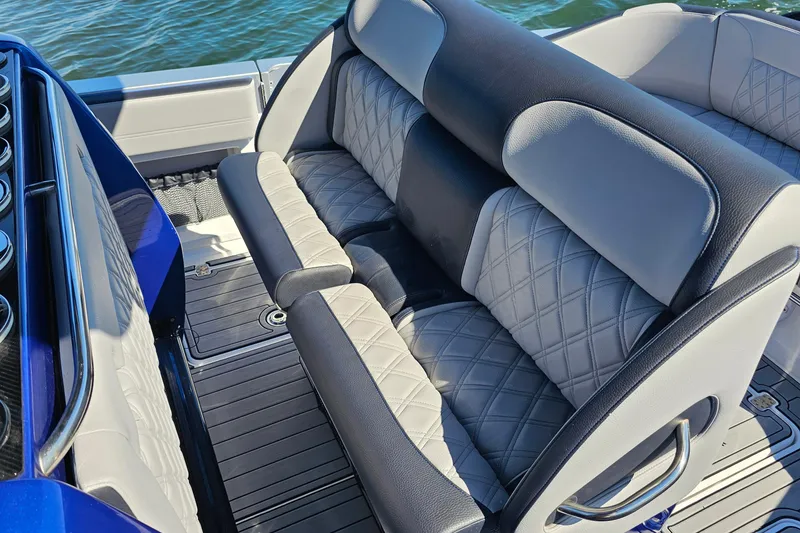 Slide: The Image of 2025 Nor-Tech 390 Sport Center Console boat with luxurious seating and quilted upholstery. - 21
