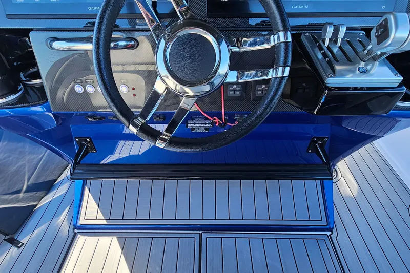 Slide: The Image of 2025 Nor-Tech 390 Sport Center Console helm with steering wheel and controls. - 27
