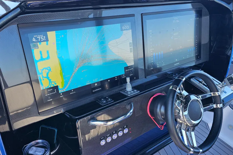 Slide: The Image of 2025 Nor-Tech 390 Sport Center Console dashboard with dual Garmin displays and steering wheel. - 28