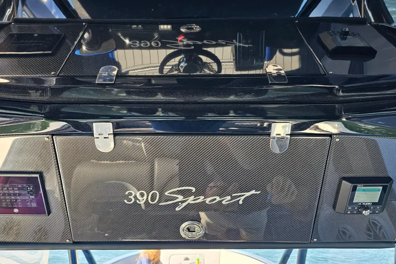 Slide: The Image of 2025 Nor-Tech 390 Sport Center Console dashboard with carbon fiber finish and electronic displays. - 30