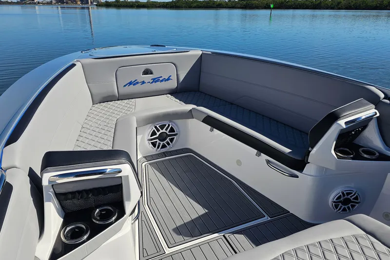 Slide: The Image of 2025 Nor-Tech 390 Sport Center Console boat interior with sleek seating and cup holders. - 37