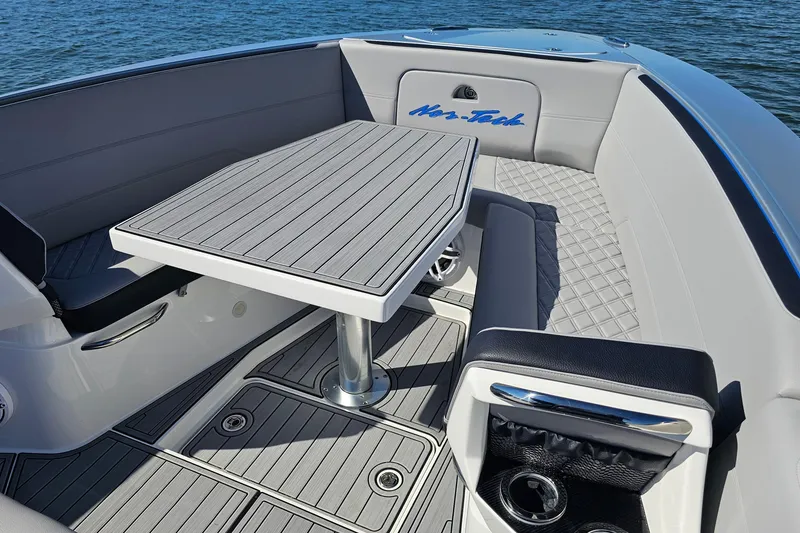Slide: The Image of 2025 Nor-Tech 390 Sport Center Console boat interior with sleek seating and table design. - 39