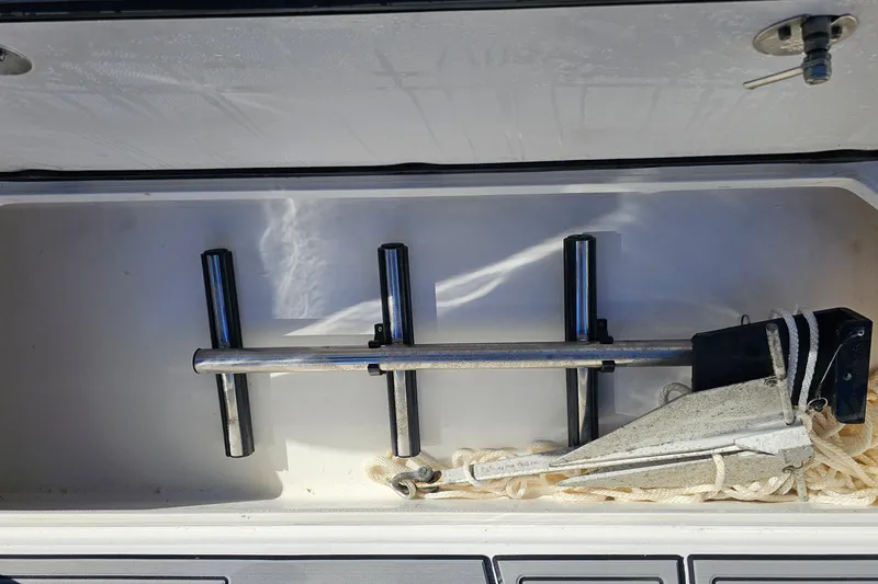 Slide: The Image of Storage compartment with anchor and rod holders on 2025 Nor-Tech 390 Sport Center Console. - 44