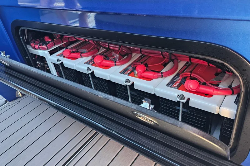 Slide: The Image of Battery compartment of 2025 Nor-Tech 390 Sport Center Console with red cables. - 45