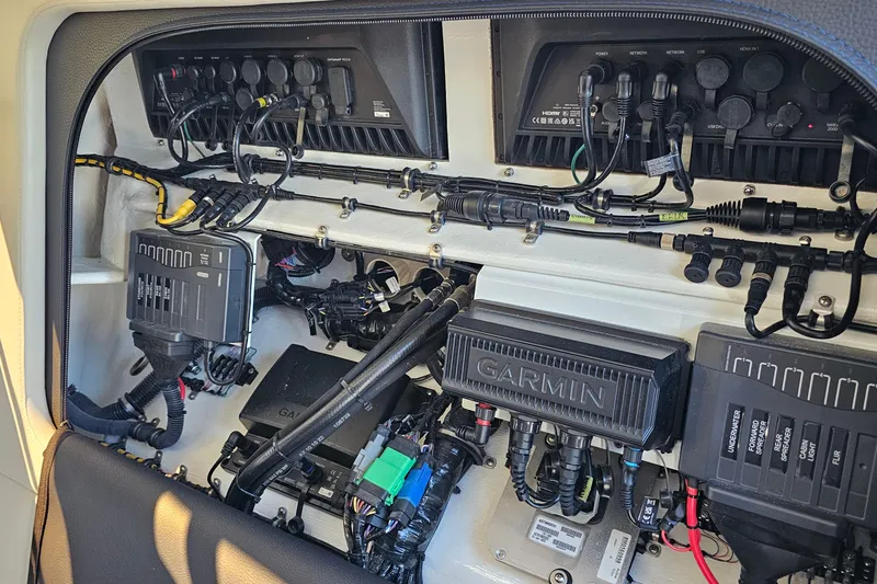 Slide: The Image of 2025 Nor-Tech 390 Sport Center Console electronics panel with Garmin systems and wiring. - 46