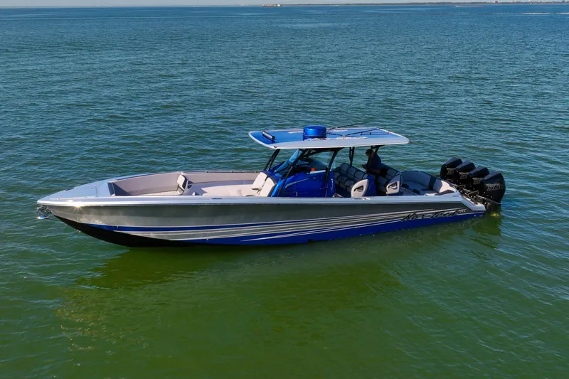 Slide: The Image of 2025 Nor-Tech 390 Sport Center Console boat on open water, side view. - 6