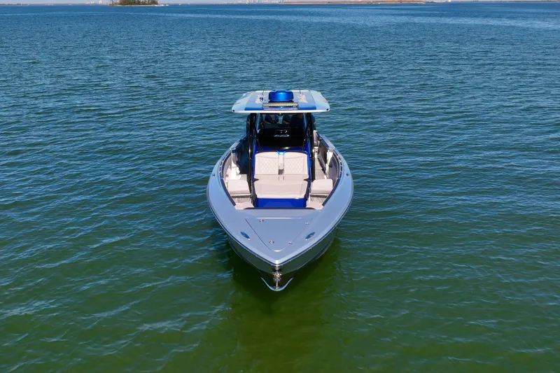 Slide: The Image of 2025 Nor-Tech 390 Sport Center Console boat on calm water, front view. - 7