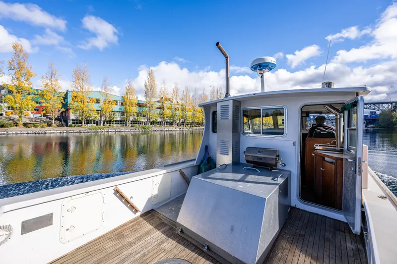 Slide: The Image of 1984 Martin Yachts Lobster Boat on scenic river with autumn trees and blue sky. - 16