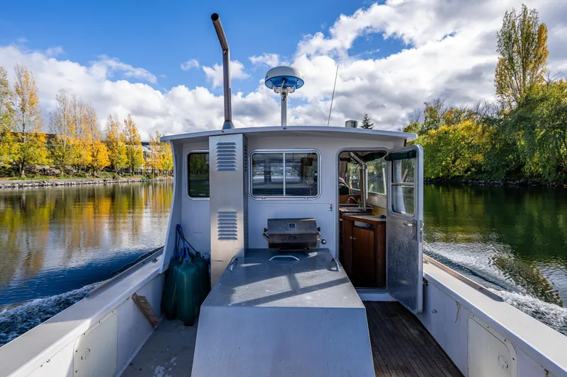 Slide: The Image of 1984 Martin Yachts Lobster Boat cruising on a scenic river with autumn foliage. - 17