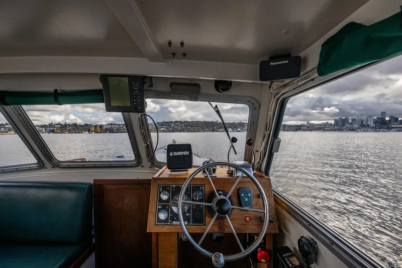 Slide: The Image of Interior view of 1984 Martin Yachts Lobster Boat with steering wheel and navigation equipment. - 23