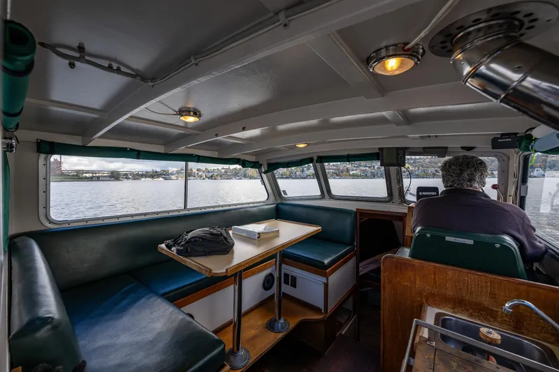 Slide: The Image of Interior of 1984 Martin Yachts Lobster Boat with seating and scenic water view. - 24