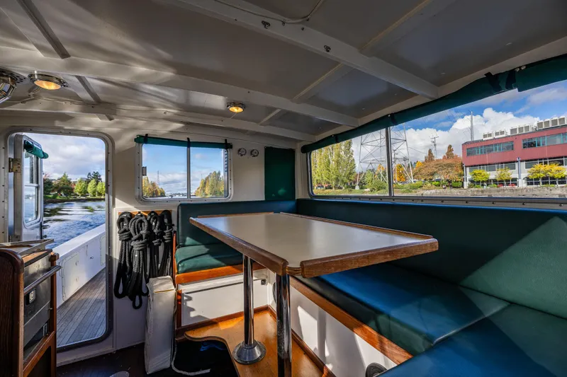 Slide: The Image of Interior of 1984 Martin Yachts Lobster Boat with seating and scenic river view. - 28