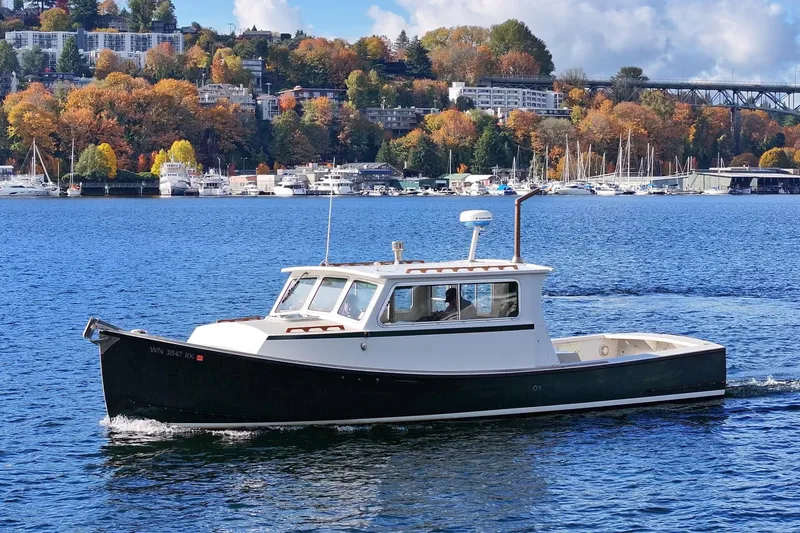 Slide: The Image of 1984 Martin Yachts Lobster Boat cruising on a scenic lake with autumn foliage. - 4
