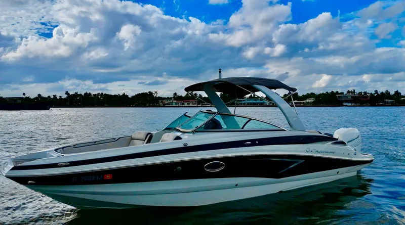 The Image of 2023 Crownline 285 XS boat on calm water under cloudy sky. - 0