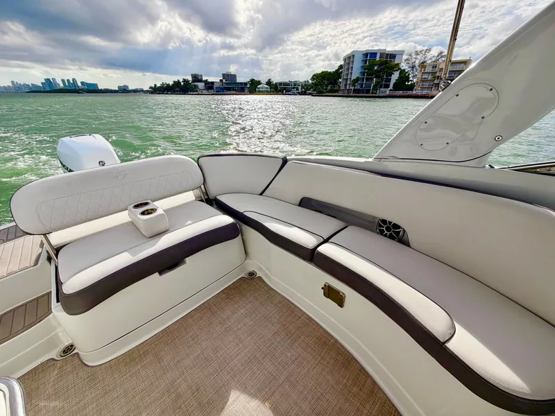 Slide: The Image of Interior of 2023 Crownline 285 XS boat with waterfront view. - 10