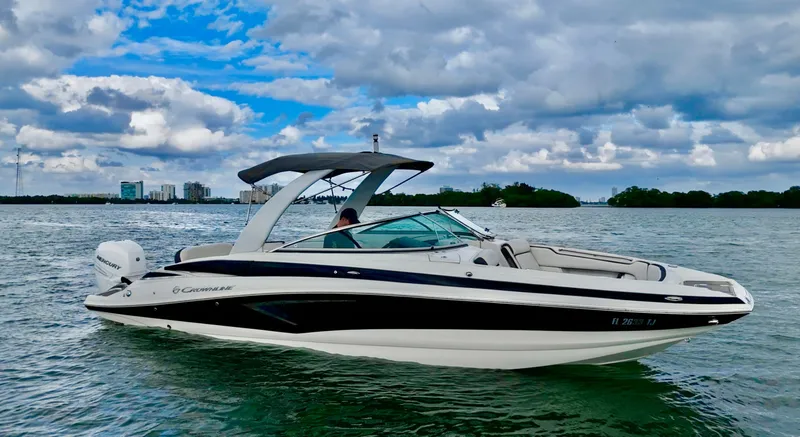 Slide: The Image of 2023 Crownline 285 XS boat on calm water under cloudy sky. - 4