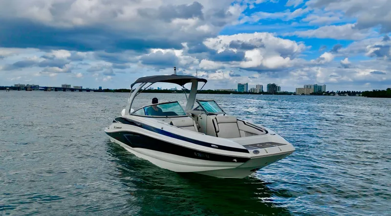 Slide: The Image of 2023 Crownline 285 XS boat on calm water under cloudy sky. - 5